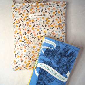Pochette livre de poche ou liseuse en coton fleuri. Fermeture par des liens à nouer.
