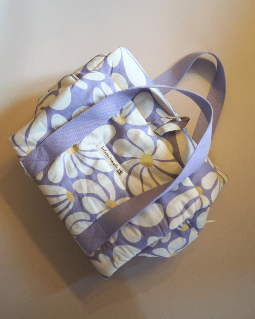 Trousse de toilette dépliante, fond lilas fleurs blanches et jaunes, intérieur vichy jaune et blanc