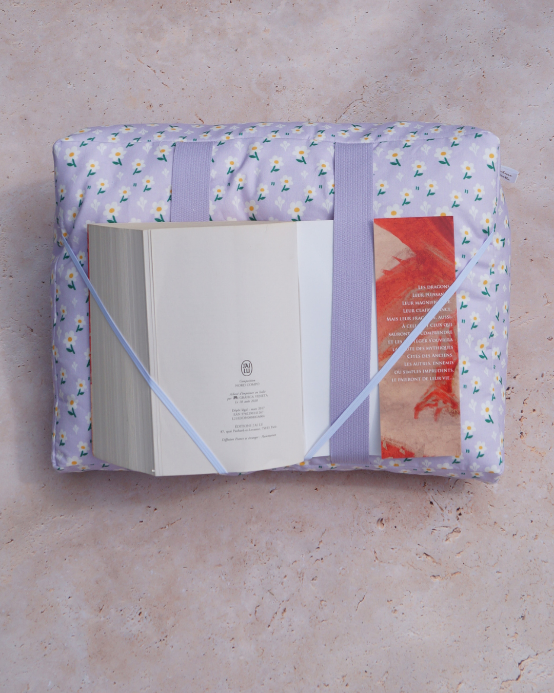 Coussin de lecture fond lilas fleurs marguerites - la couverture est tenue par les sangles